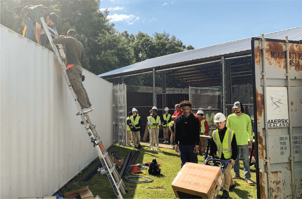 Chickasaw students help move materials during the solar array installation. 